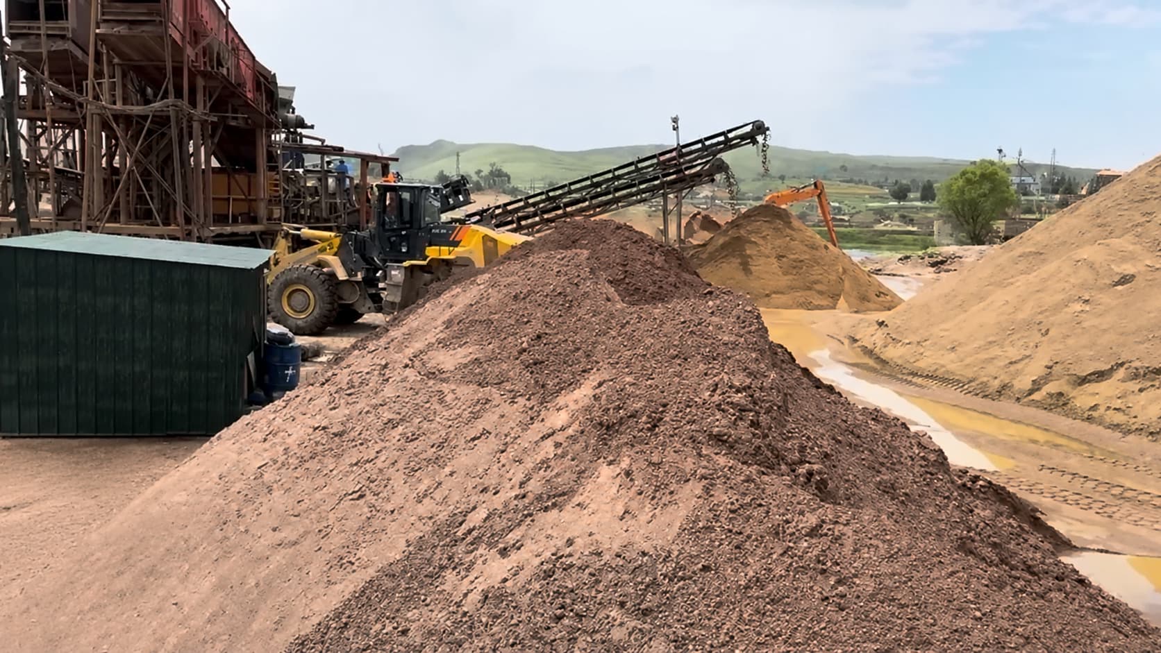 Raw alluvial river garnet stockpiles awaiting selection at a garnet processing site
