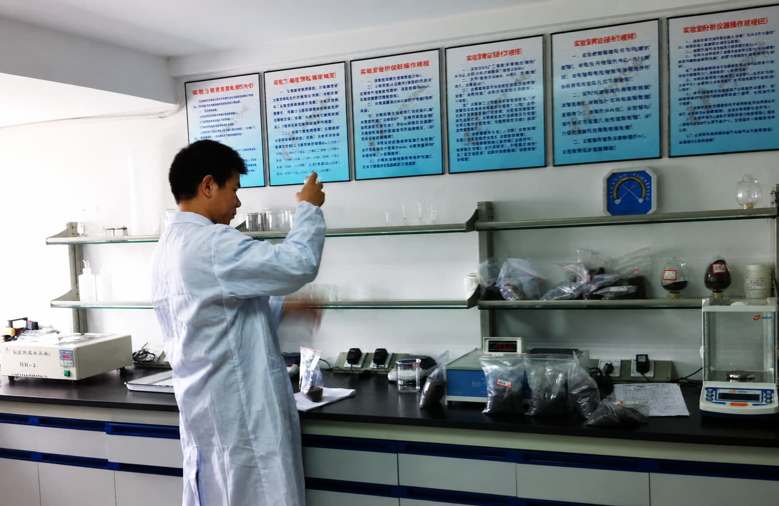 SEPPE laboratory technician inspecting a garnet sample for batch quality control