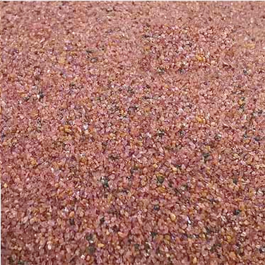 Close-up of SEPPE SGA 80 mesh pink garnet abrasive grains for waterjet cutting