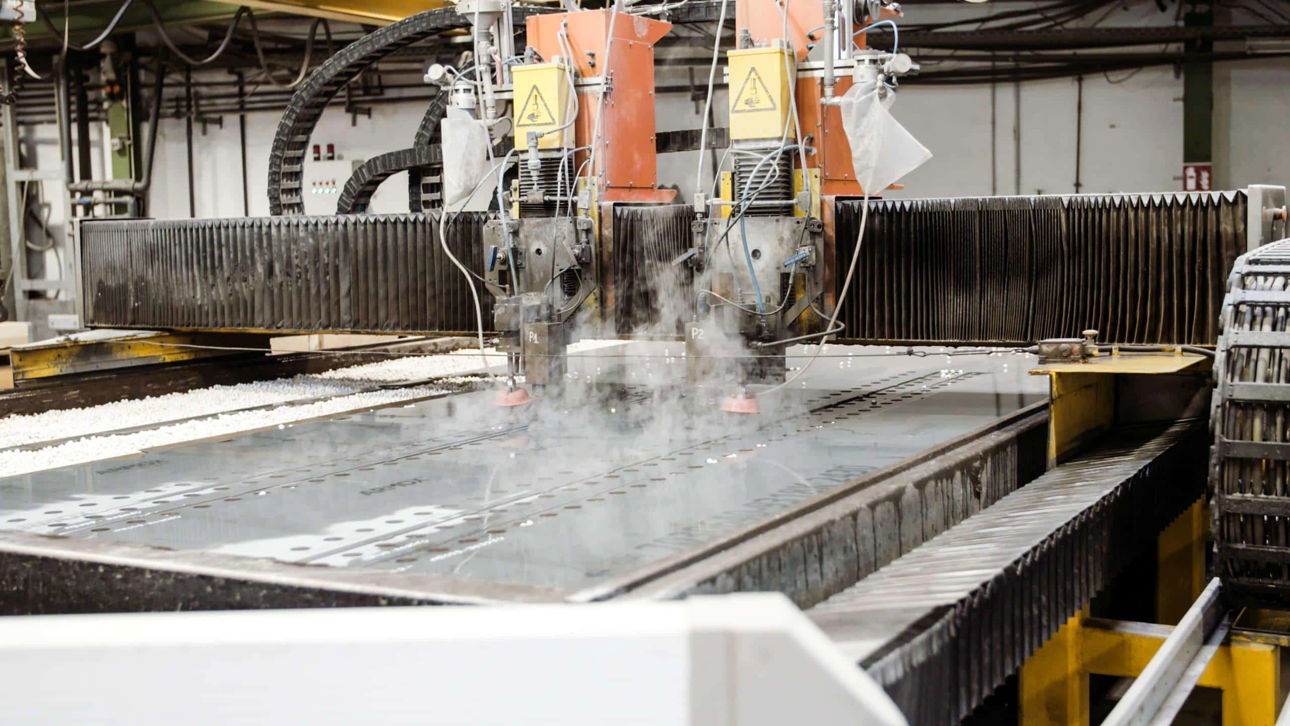 Industrial abrasive waterjet cutting a metal plate